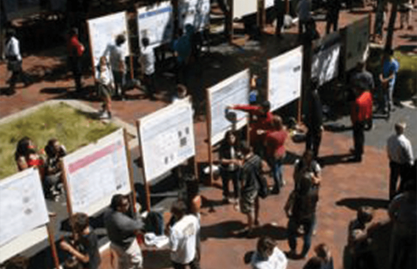 A crowd dispersed among research posters