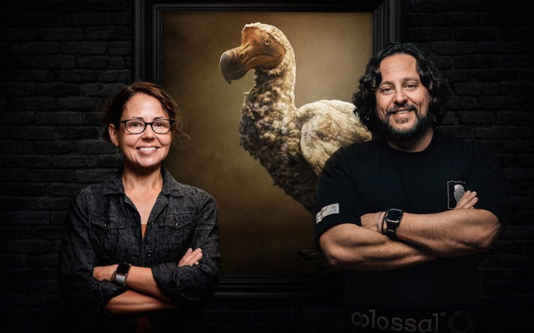 Beth Shaprio and Ben Lamm from Colossal Biosciences stand in front of a large replica of a dodo bird.